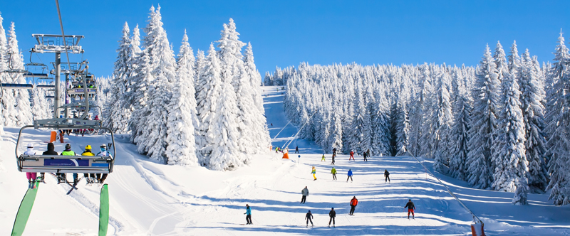 Skiers on a snowy mountain slope representing Granite Peak Ski Area